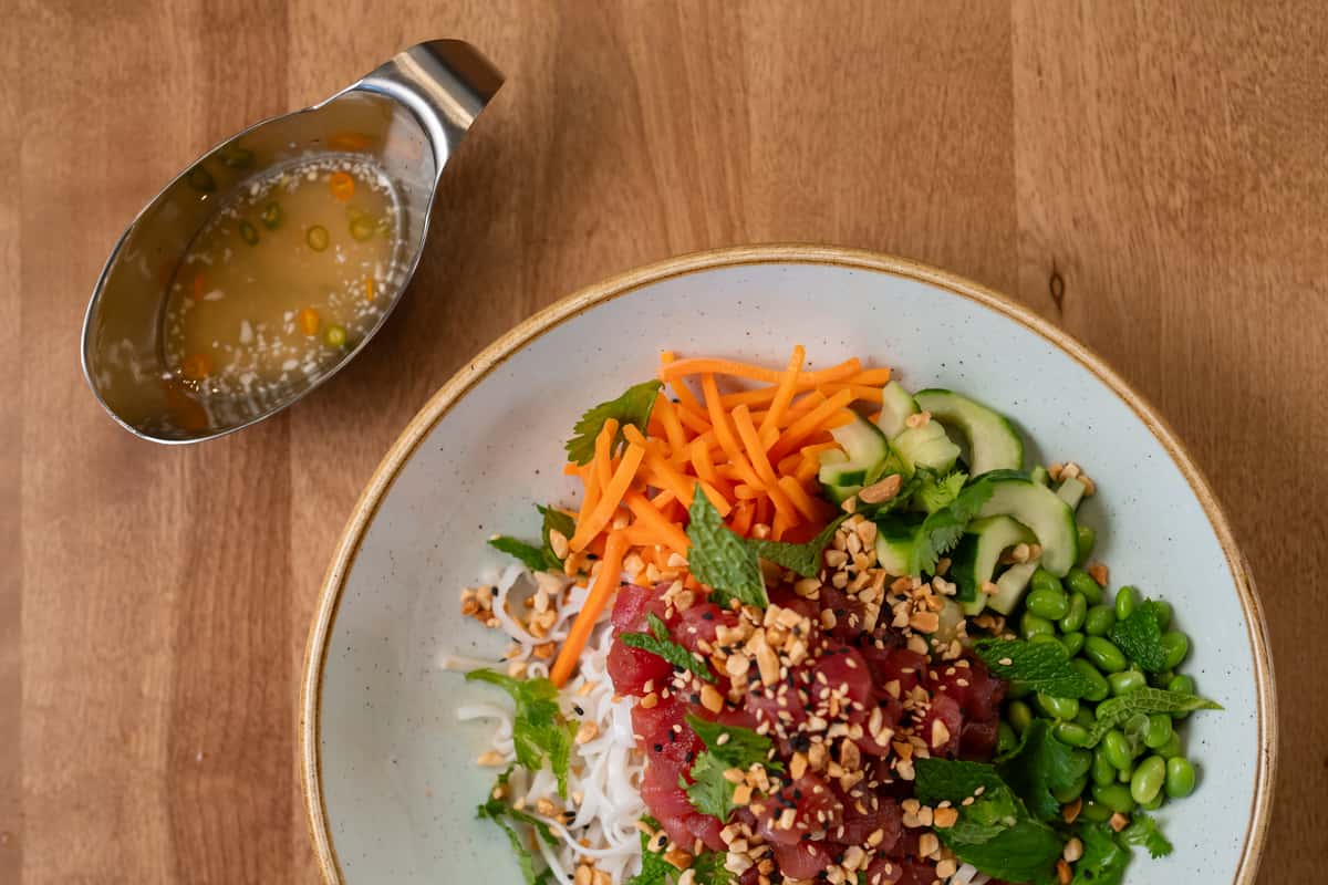 bowl with tuna, rice, veggies and sauce