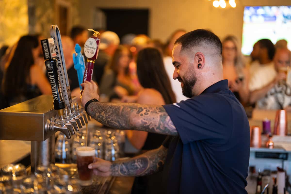 Man pouring beer from draft