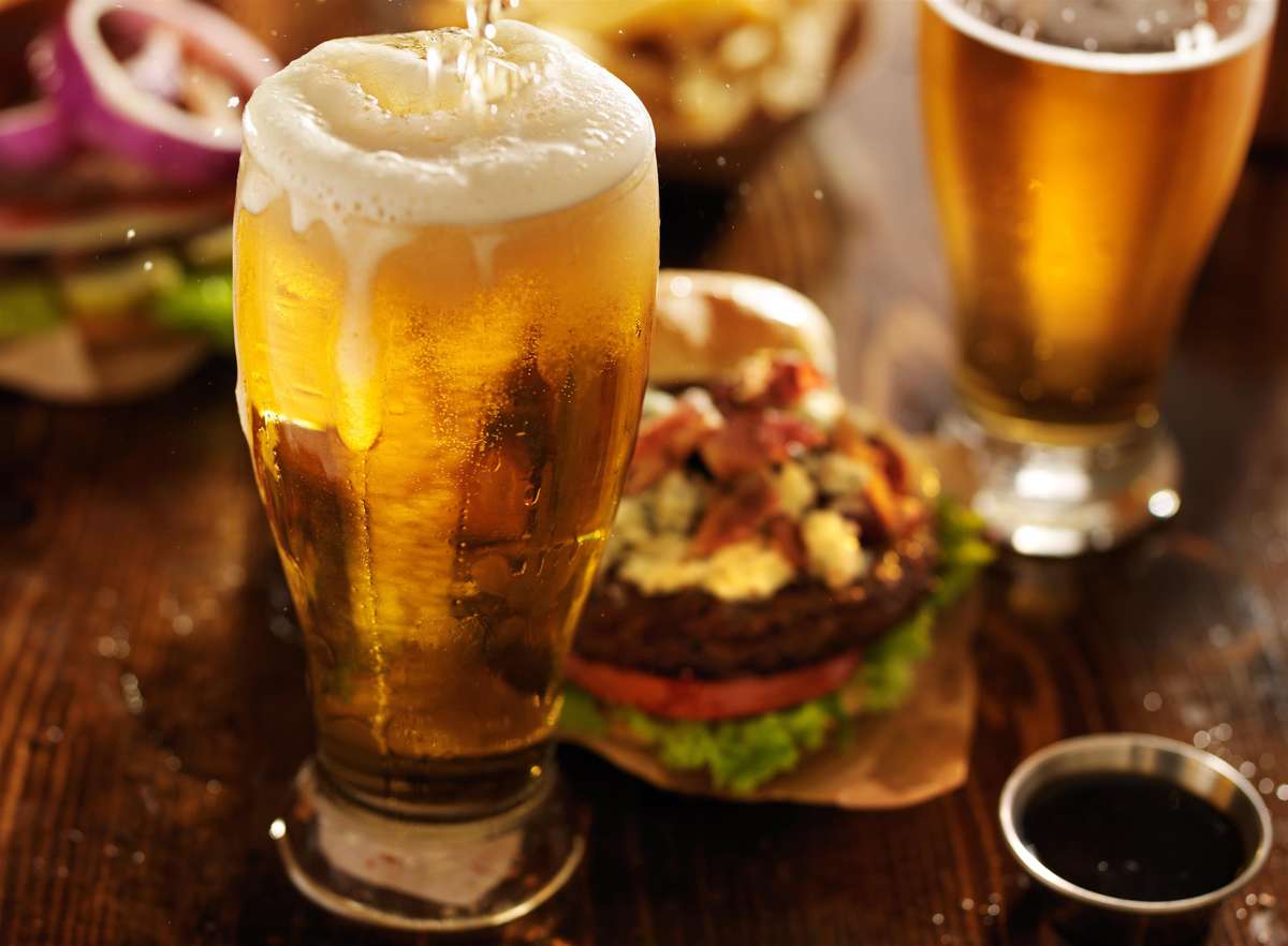hamburger and a beer in a glass