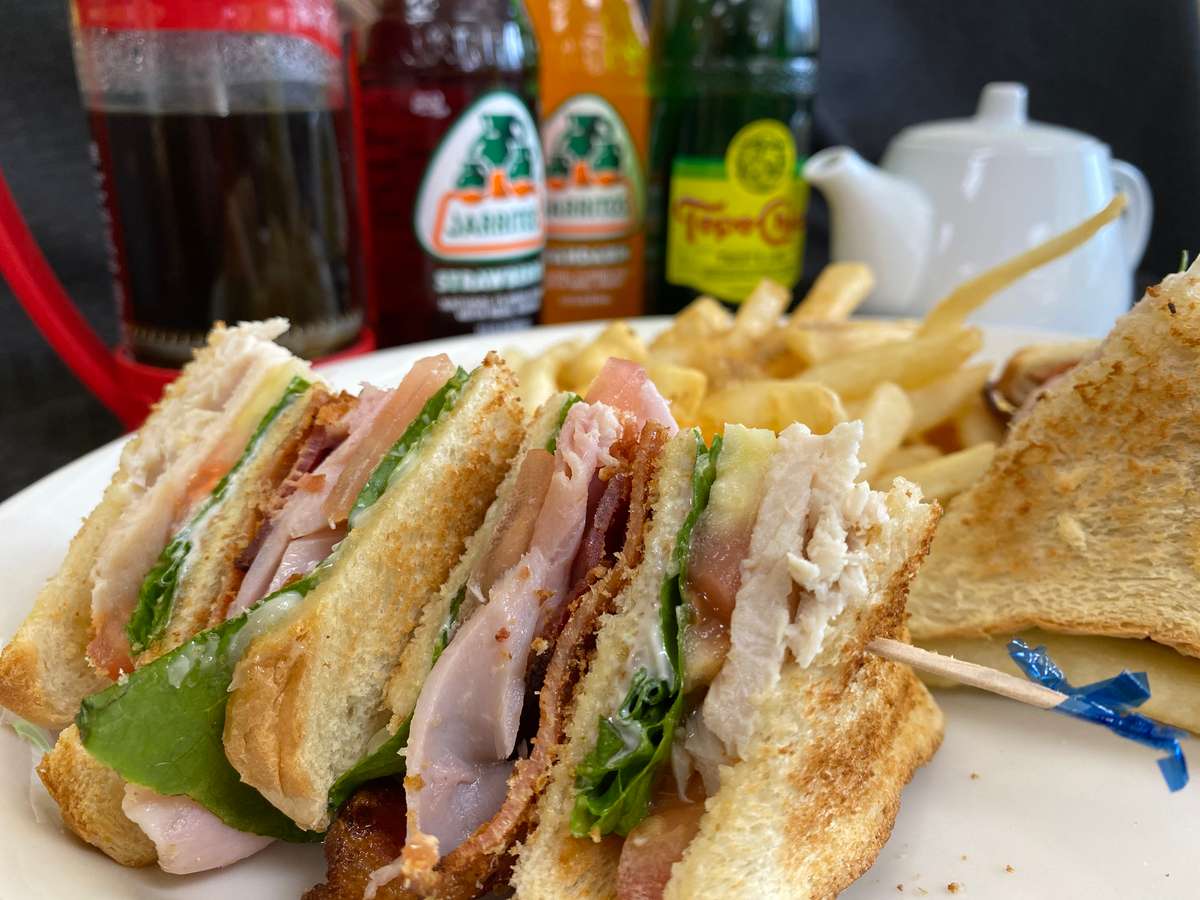 Club sandwich, french fries, and colorful drinks served at Boulevard Cafe.