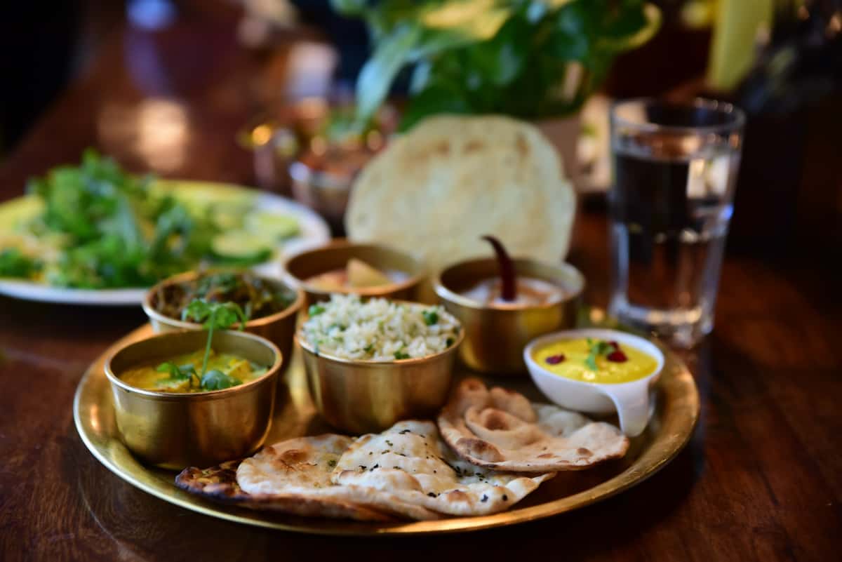 closeup shot indian tasty food called marwari veg thali wooden table