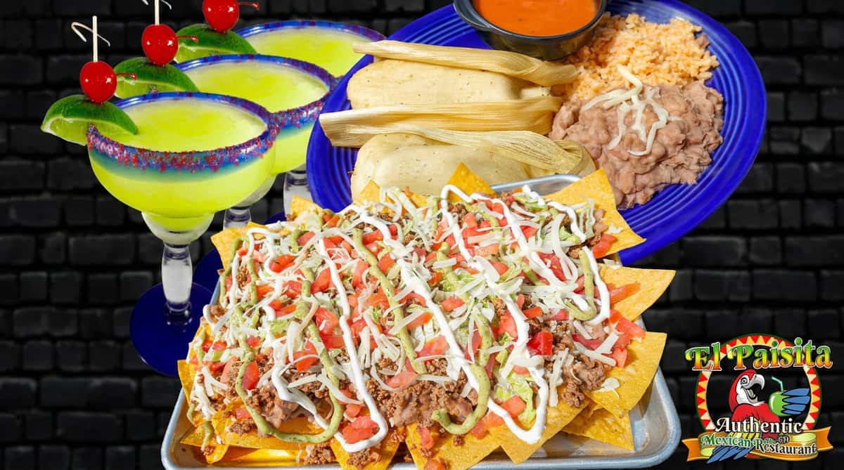 Nachos with ground meat, lettuce, tomatoes, and sauces; a plate of tamales, rice, beans, and salsa; and two margaritas.