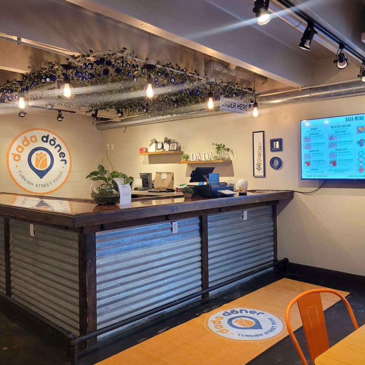 Dada Döner Turkish Street Food ordering counter with modern décor, digital menu boards, and a welcoming fast-casual dining atmosphere