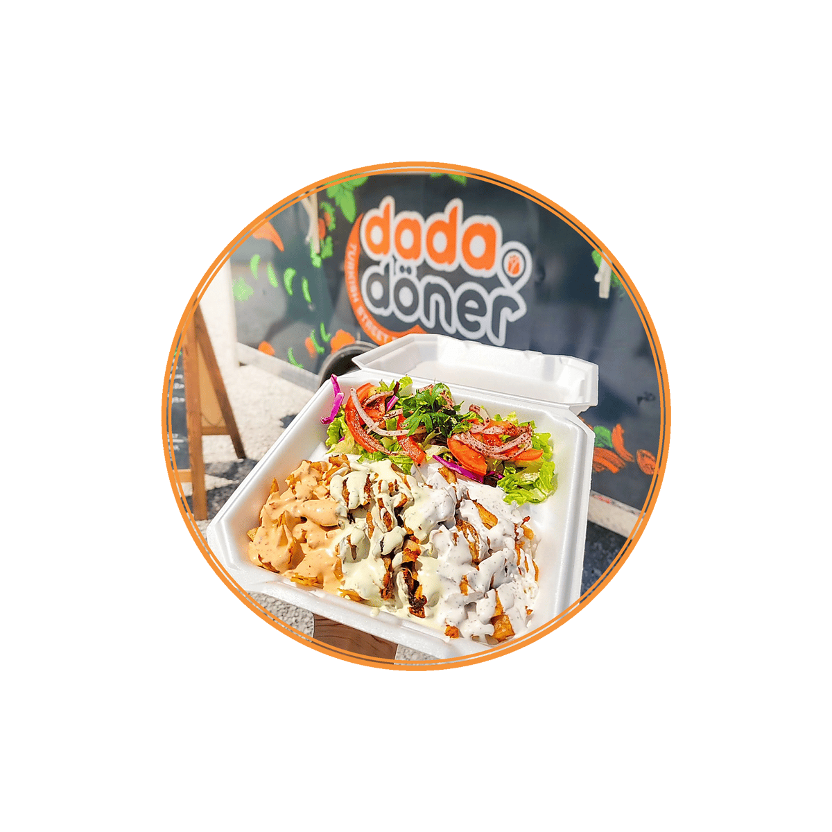 Doner kebab plate with seasoned sliced meat, crispy fries, creamy sauces, and a fresh garden salad