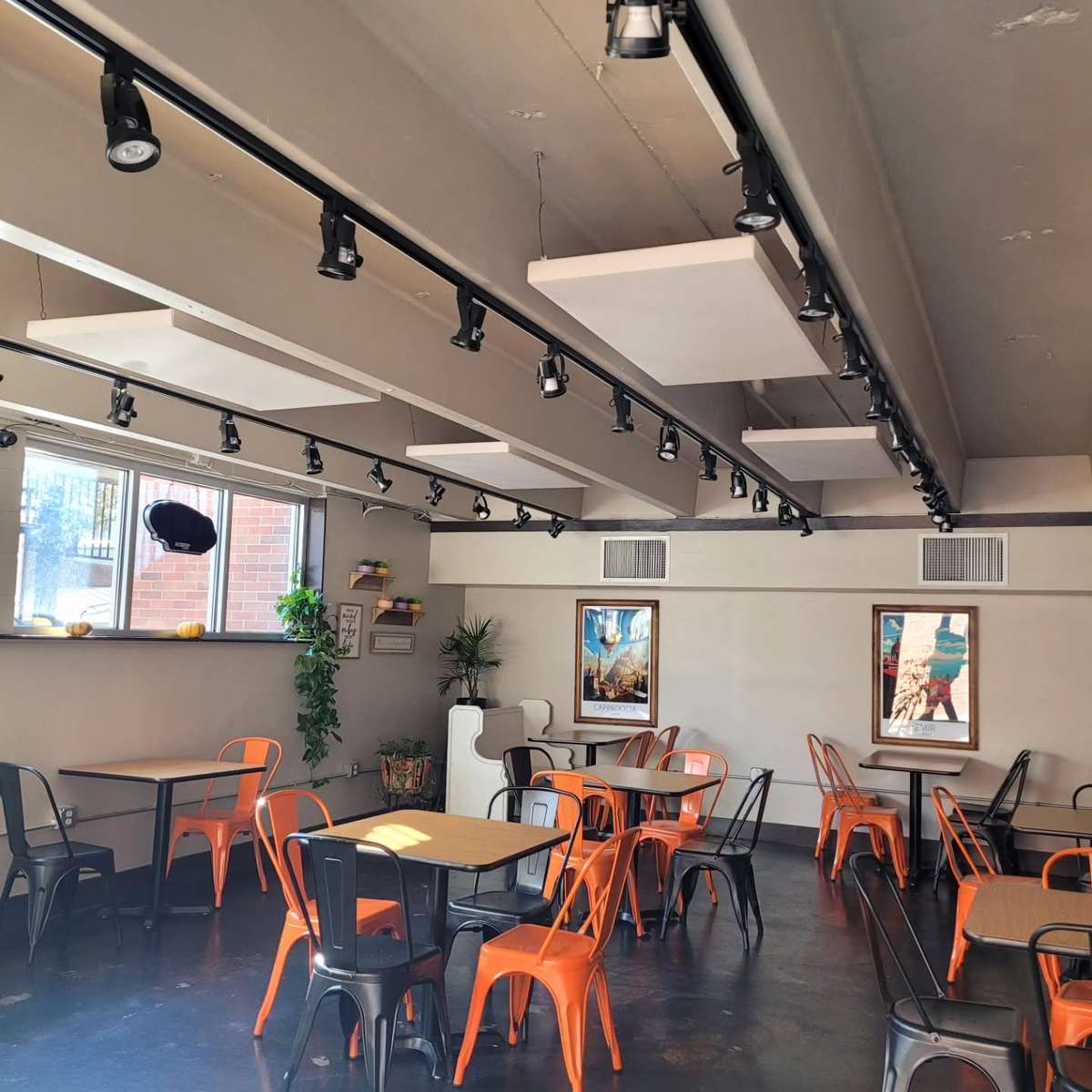 Modern Turkish restaurant dining area with orange and black seating, contemporary décor, and a bright, welcoming atmosphere for casual dining