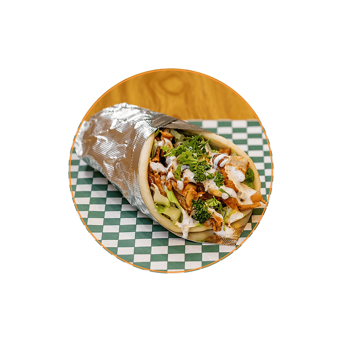 Chicken shawarma wrap topped with garlic sauce, fresh herbs, and crisp vegetables in warm pita bread