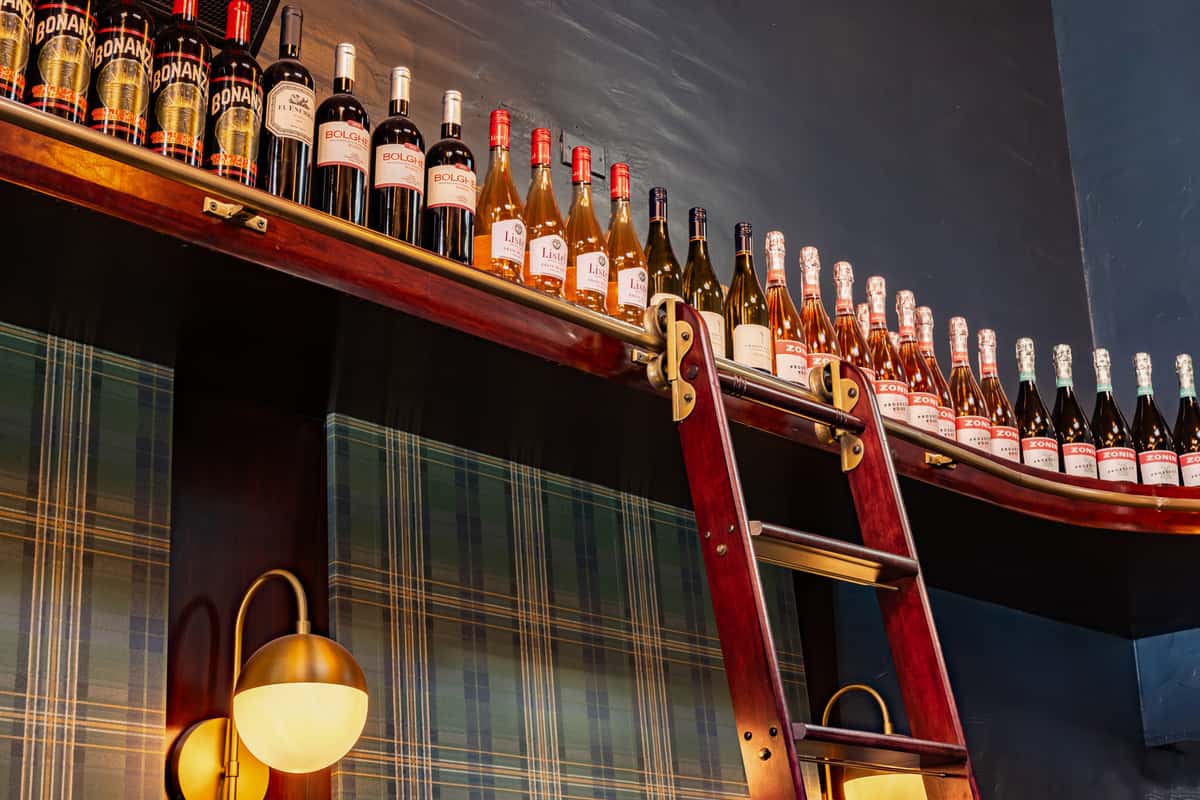 upper shelf of wine bottles