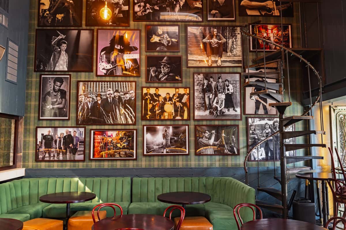 wall of framed photos of bands