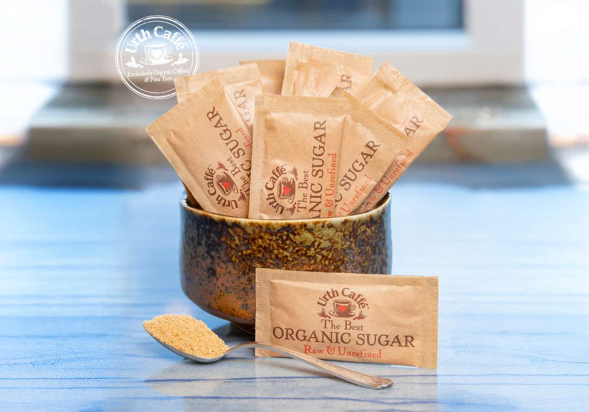 Urth Raw Sugar packets in bowl with spoon of sugar