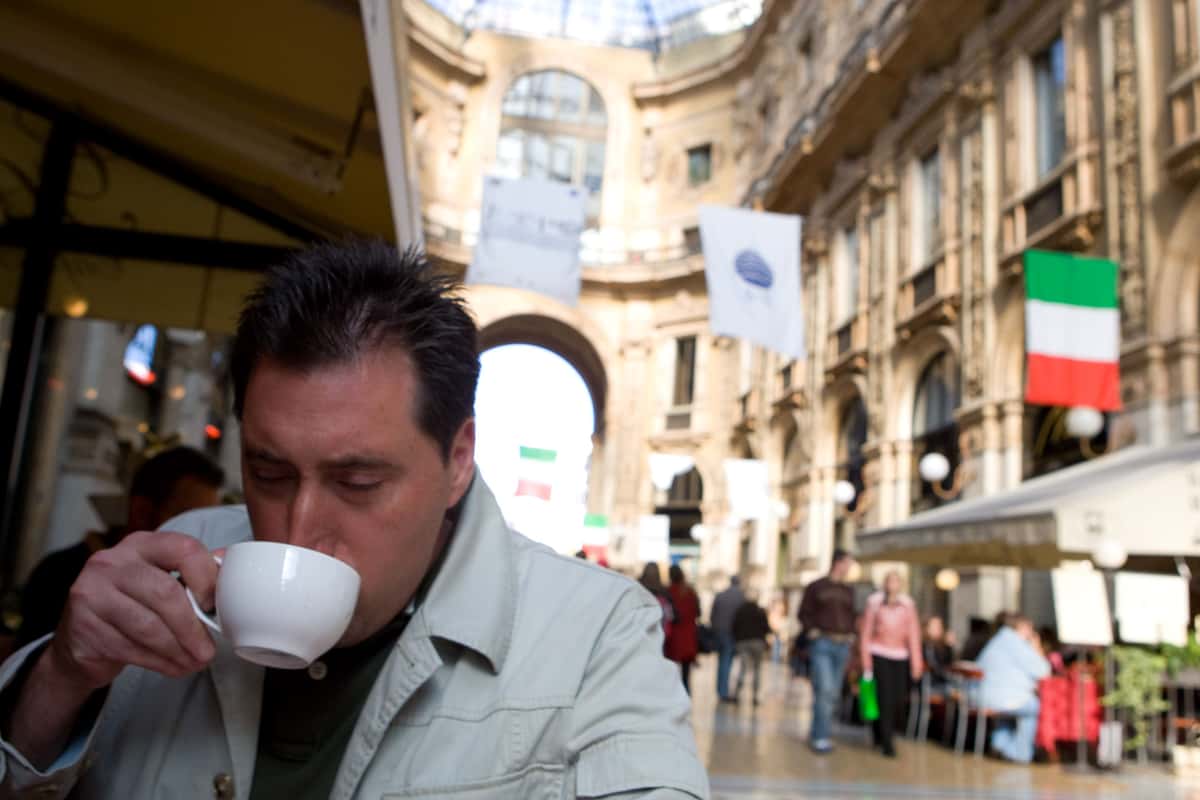 Man sips caffe latte outside a cafe in Venice Italy.