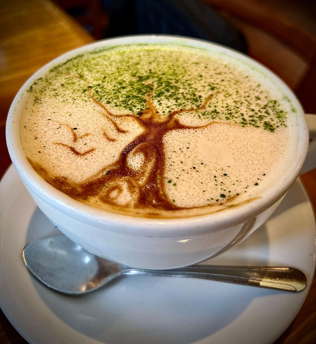 Caffe Pistachio Latte with beautiful latte art of "Tree of Life" or pistachio tree