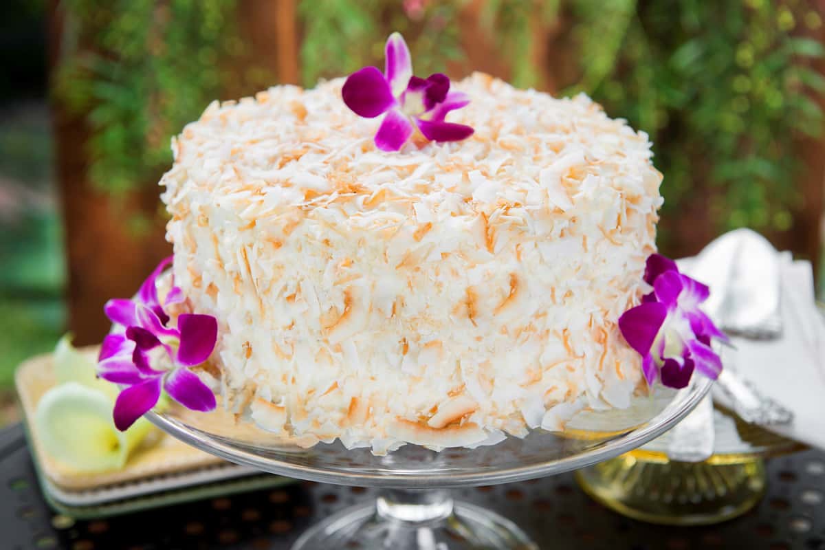 White cake with toasted coconut on it
