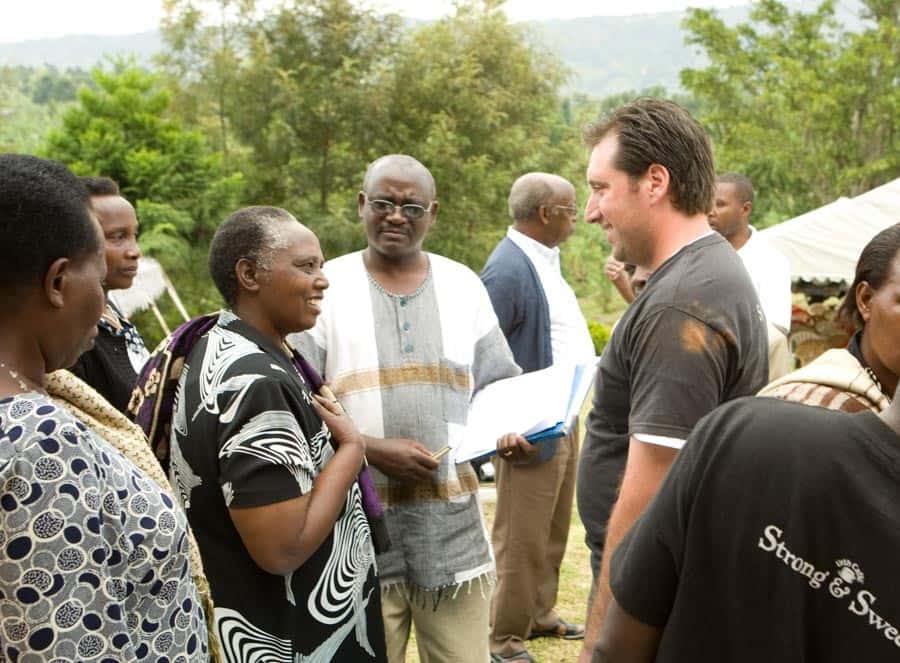 Shallom Berkman, at right, speaks with coffee farming leaders in Uganda