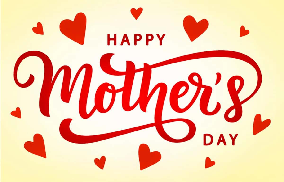 Red script type that says Happy Mother's Day with three red hearts at slight angles above and below. The background is a light yellow glow.