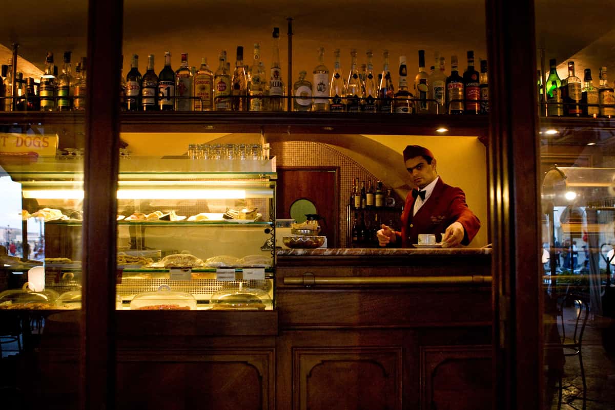 Waiter is viewed behind the counter at a cafe in Venice Italy