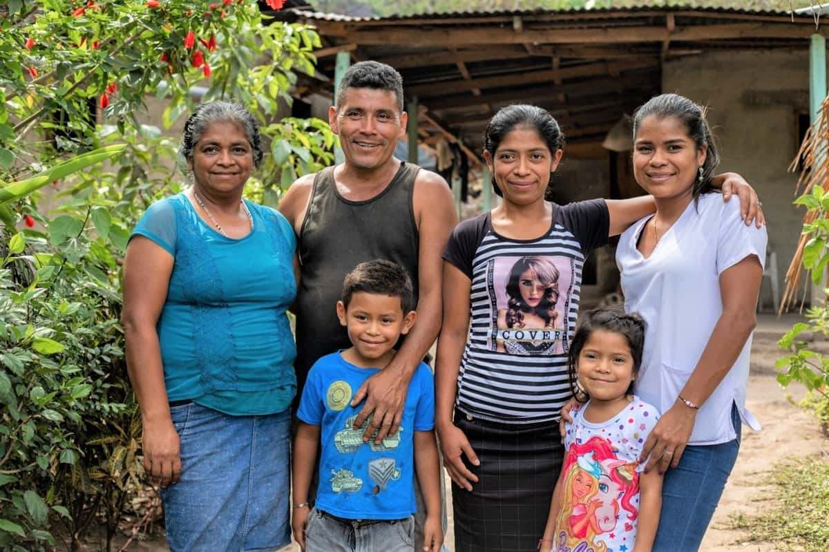 Photo of Francisco Polanco with his wife, three daughters and son in from of their farm.