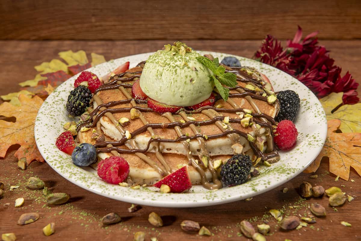 Chocolate Pistachio Pancakes with Urth Pistachio Butter and Hazelnut Cream and adorned with fresh berries