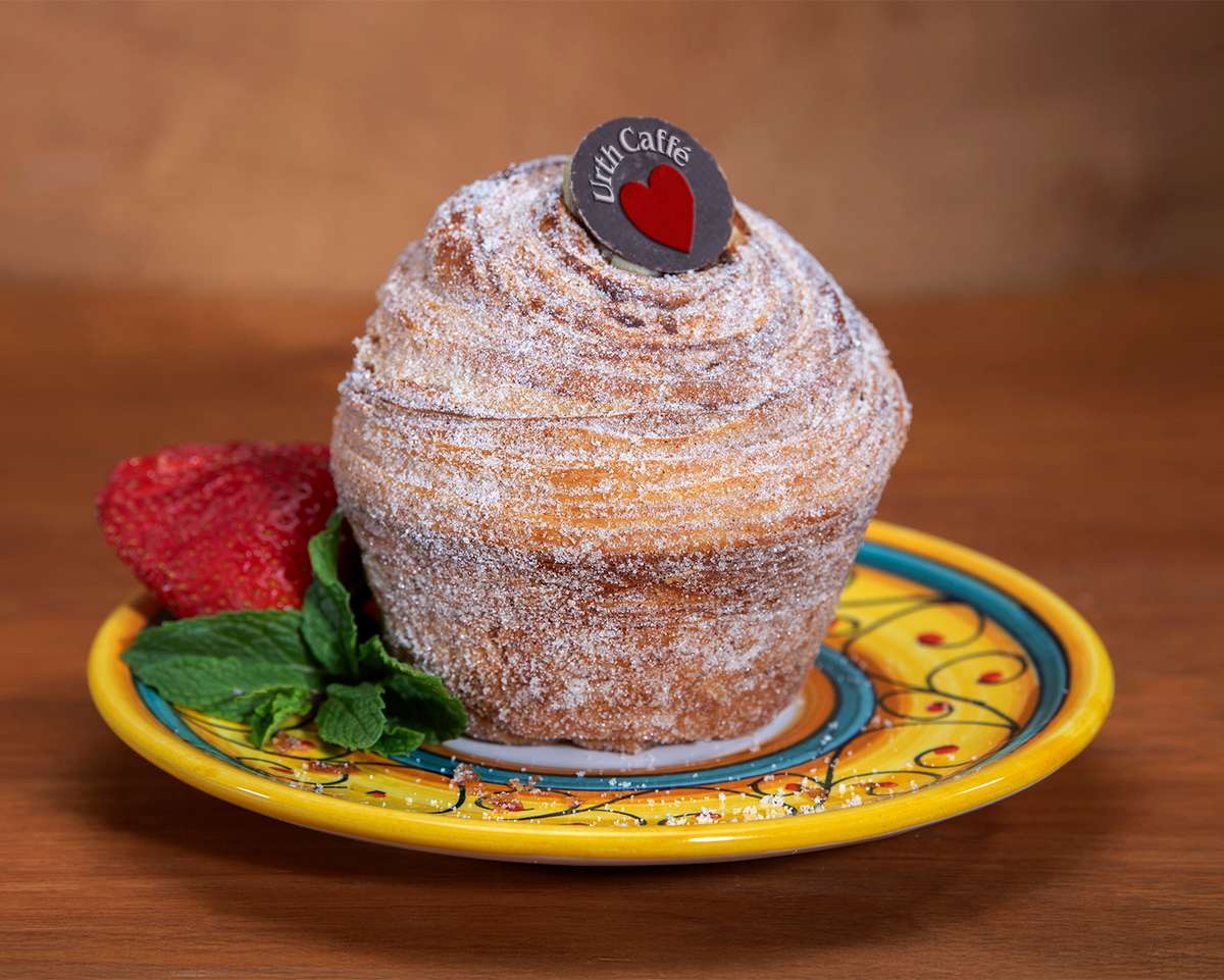 Churro Delight on a ceramic plate with a rose