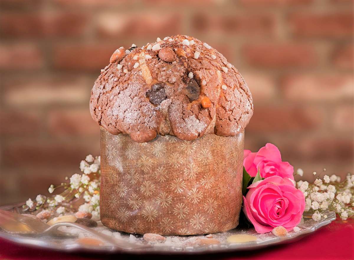 Valentine Panettone on a plate with pink roses and baby's breath flowers 