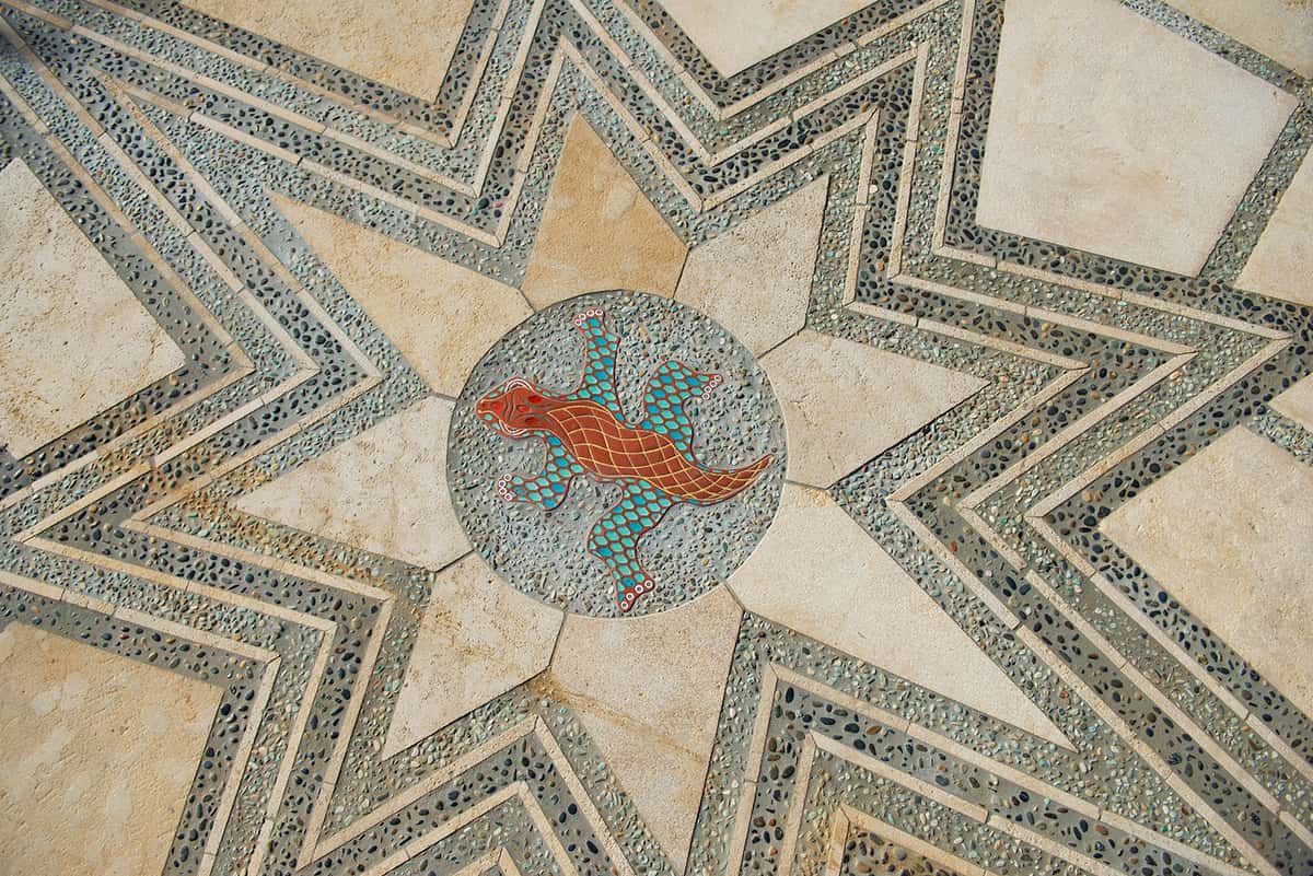 Closeup of tile floor - star shape surrounding circle with gecko design