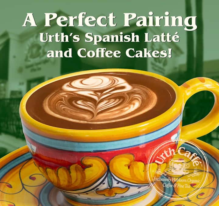 Photo of a colorful ceramic cup and saucer with brown and white latté design on top.