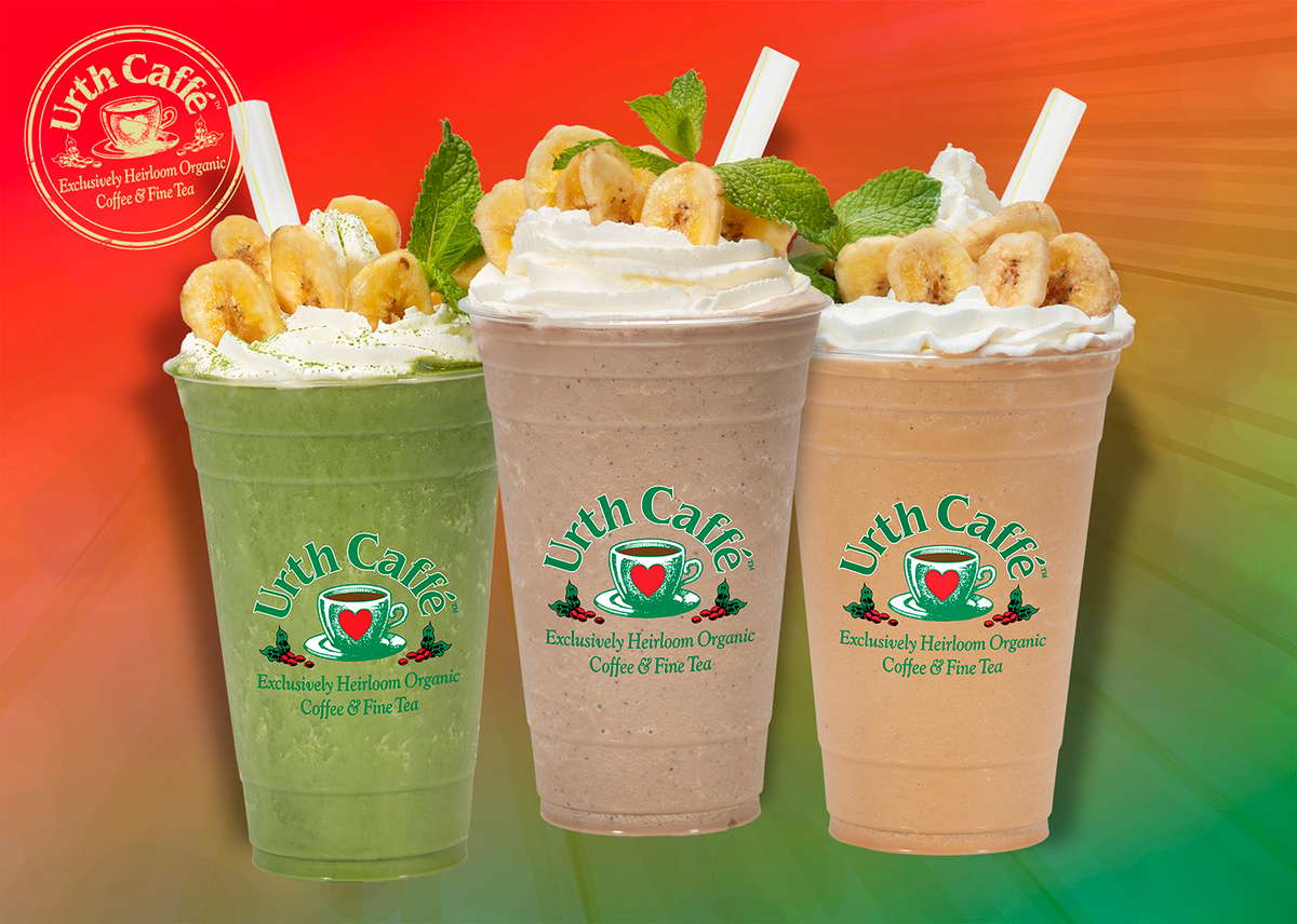 Three Urth Caffé Monkey Granitas banana milkshakes in clear to go cups topped with whipped cream and garnished with crispy banana chips and a straw. From left to right is the Green Monkey made with matcha, then the Brown Monkey made with espresso and on the right is the Red Monkey made with Rooibos tea.