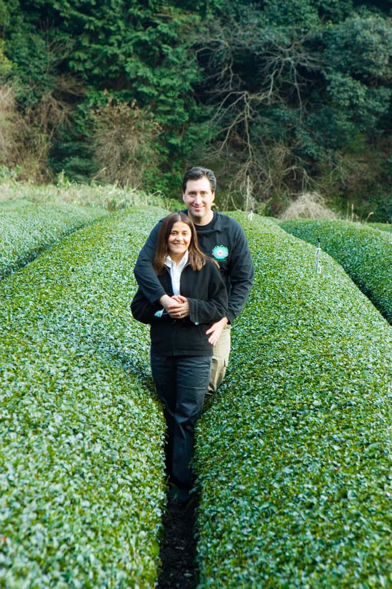 Jilla and Shallom Berkman stand amid rows of tea plants