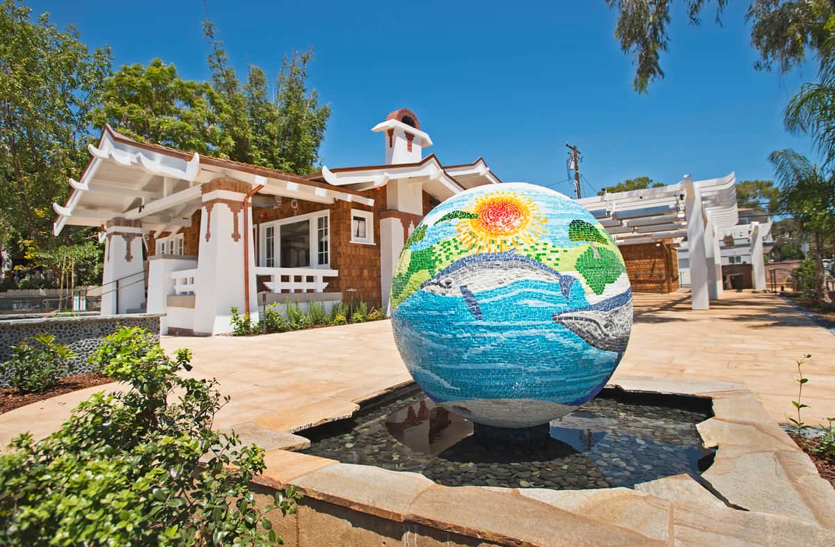 Mosaic globe of the earth with whales in the oceans fountain with whales located at the front corner of the large patio.