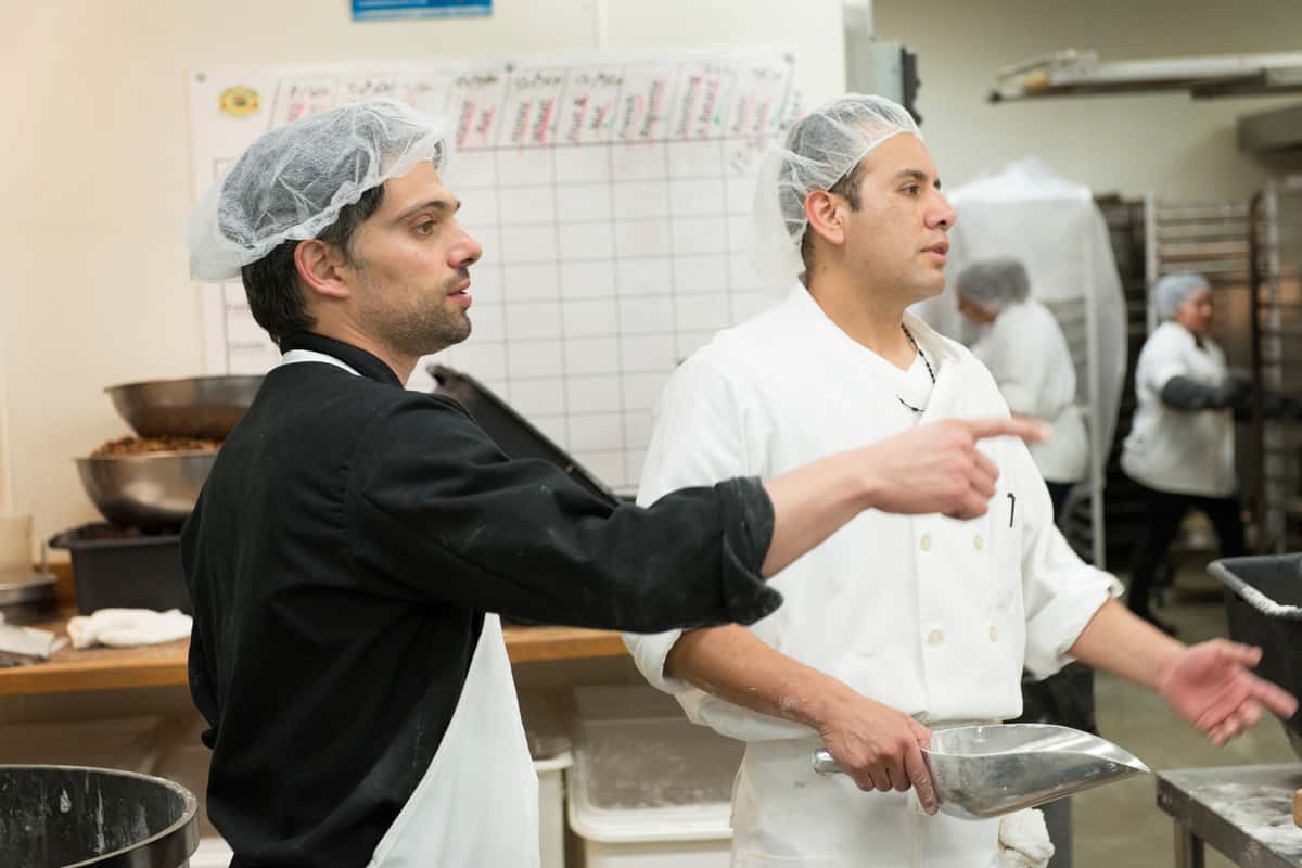Chef Davide Giova directs another man in the Urth Bakery