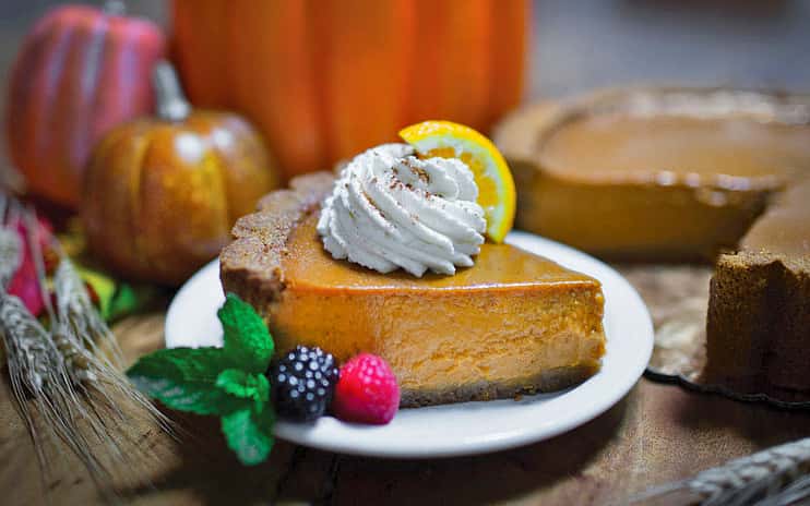 Slice of pumpkin pie with dollop of whipped crea,