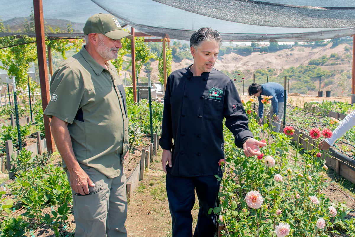Chef Giova and Jules Lieb in the flower garden of Mulholland Estate