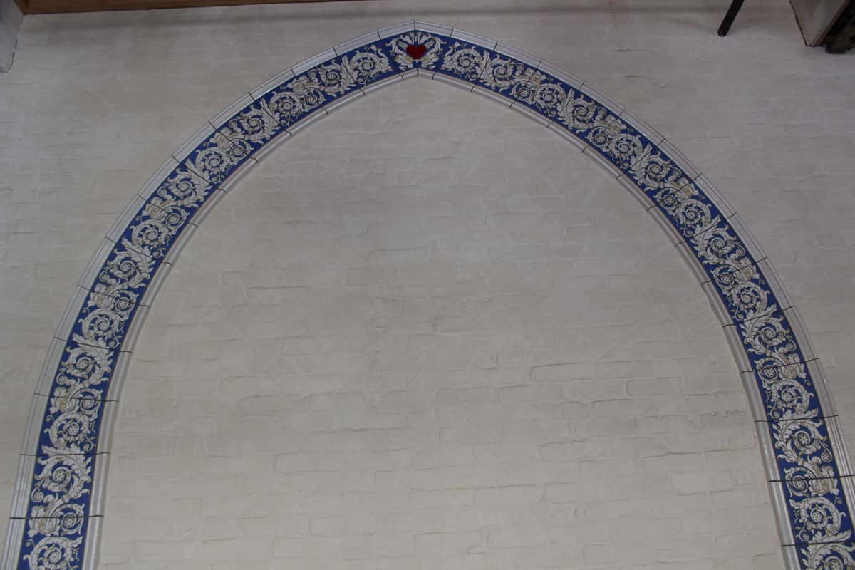 Blue and white tile arch on a white wall