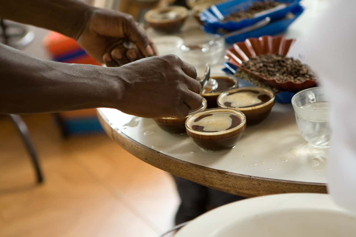 The "cupper" breaks the "crust" formed on top of the coffee