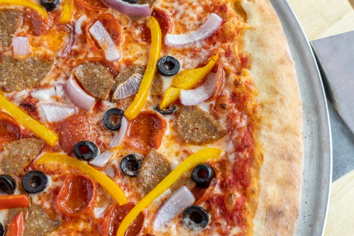 Person Cutting Pizza