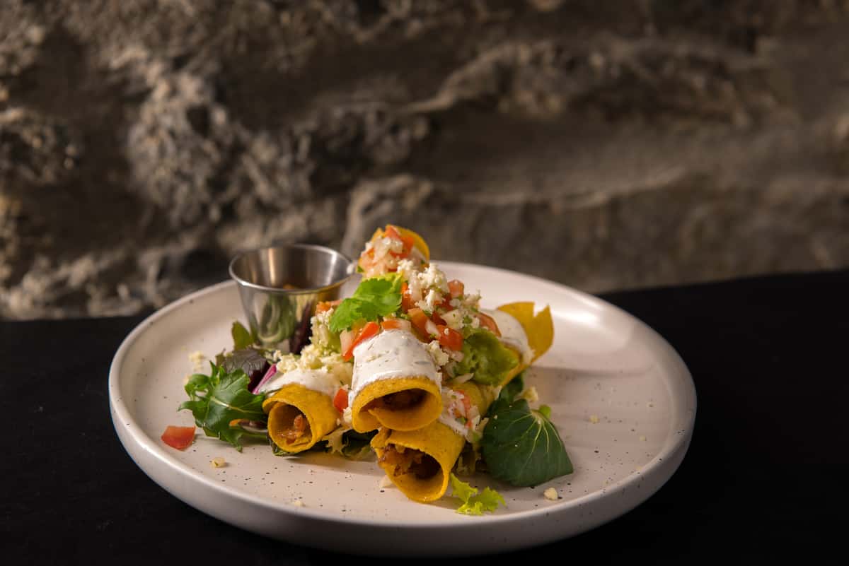 pork flautas in a white plate
