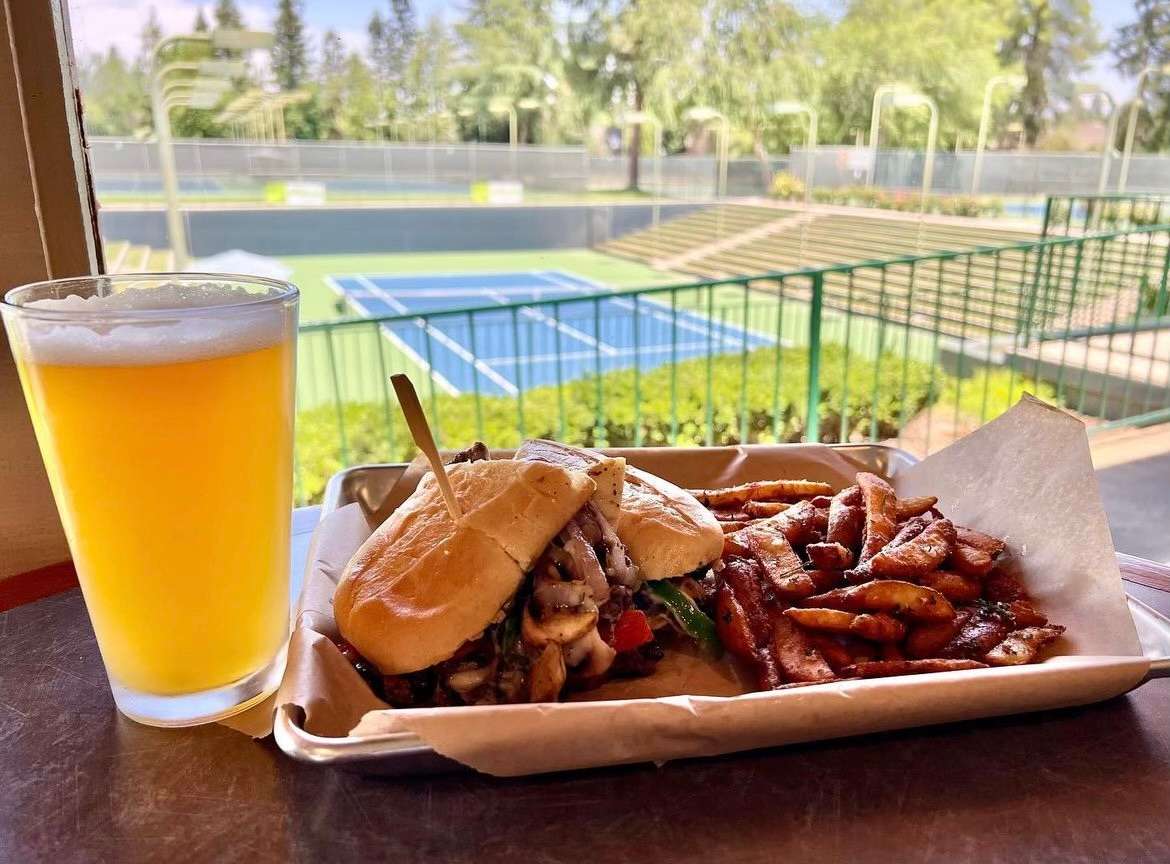 Madera location beer and food with tennis court in background