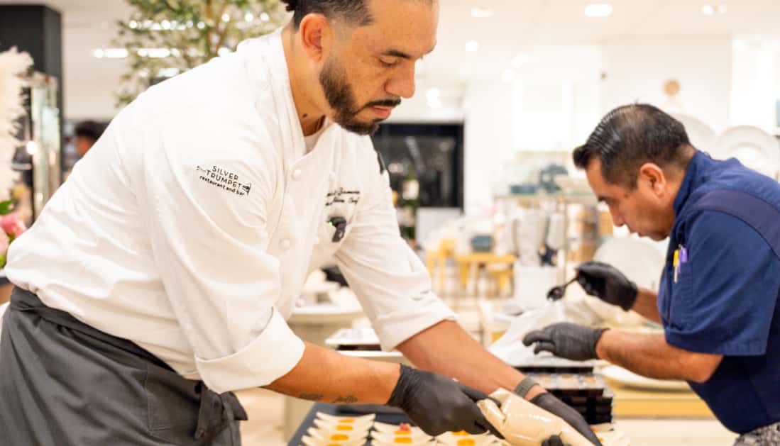 Executive Chef Hector Zamora and team plating dishes.