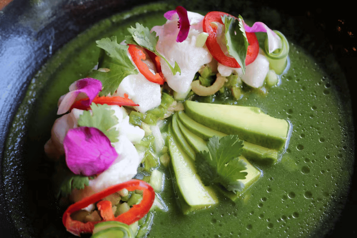 Fresh green ceviche with avocado, cucumber, radish, and herbs, beautifully presented at Hugo's restaurant.