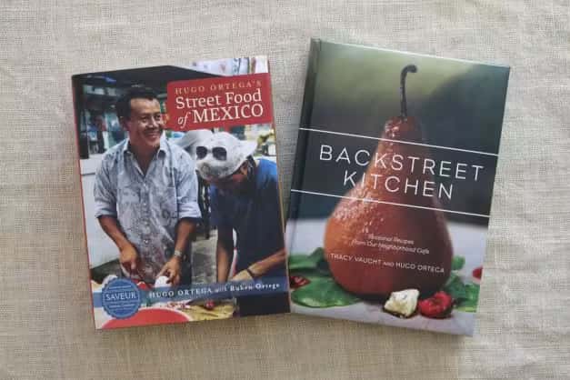 Hugo Ortega's Street Food of Mexico and Backstreet Kitchen cookbooks displayed with a branded cocktail, perfect for food lovers and culinary gifts.