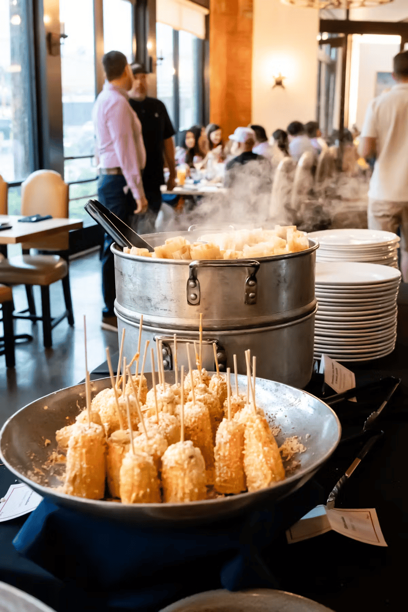 Fresh churros frying in hot oil during Hugo's Cinco de Mayo celebration, served warm with traditional Mexican flavors.