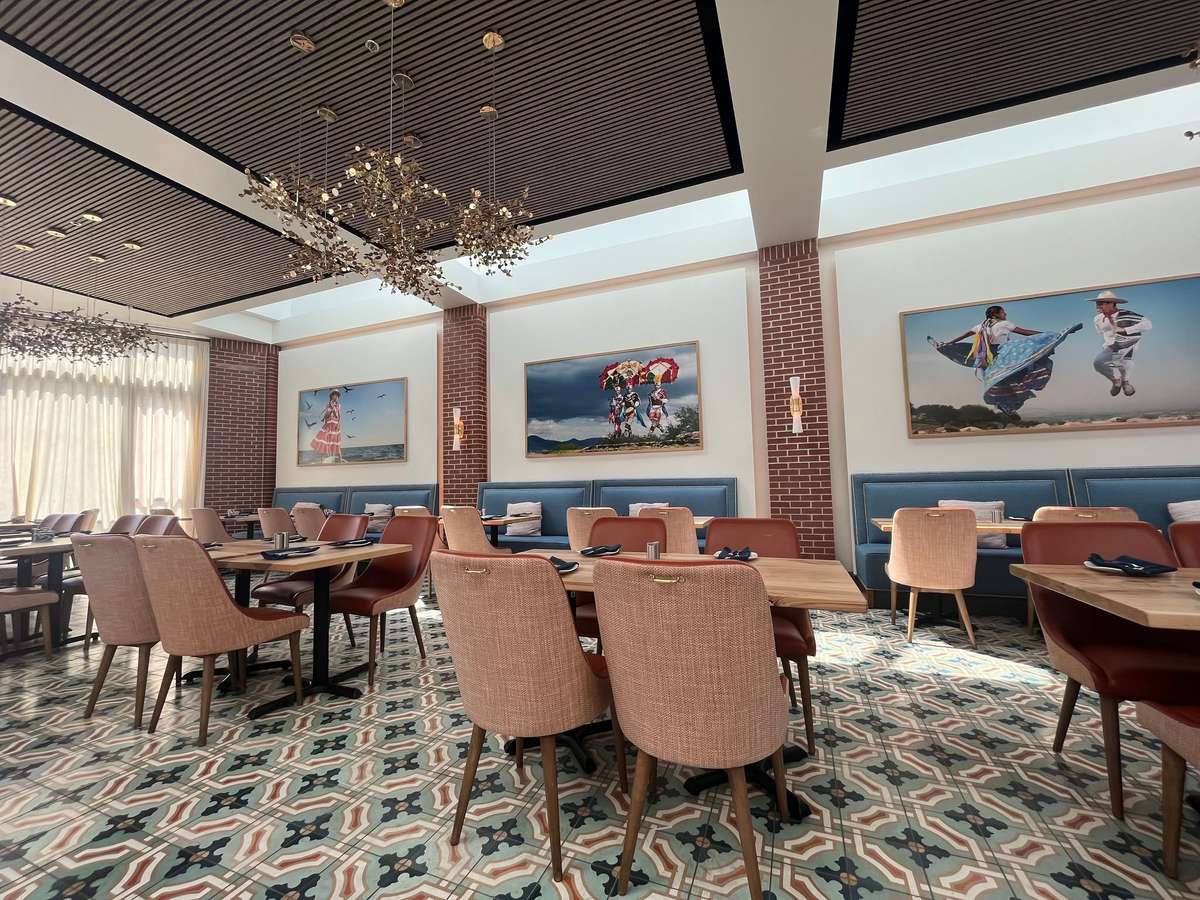 Upscale dining room at Hugo's restaurant featuring elegant seating, modern artwork, and a warm, welcoming atmosphere.