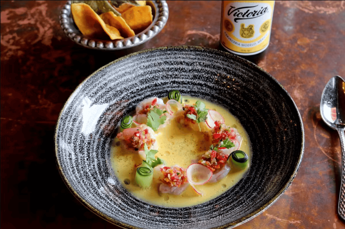 Creamy seafood appetizer with fresh shrimp, avocado, and vibrant garnishes served at Hugo's restaurant.