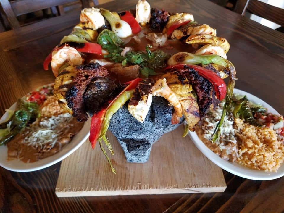 molcajete with assorted meats and vegetables