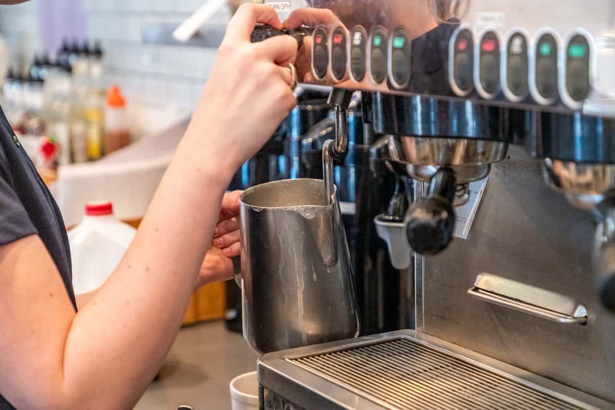Cafe worker making coffee
