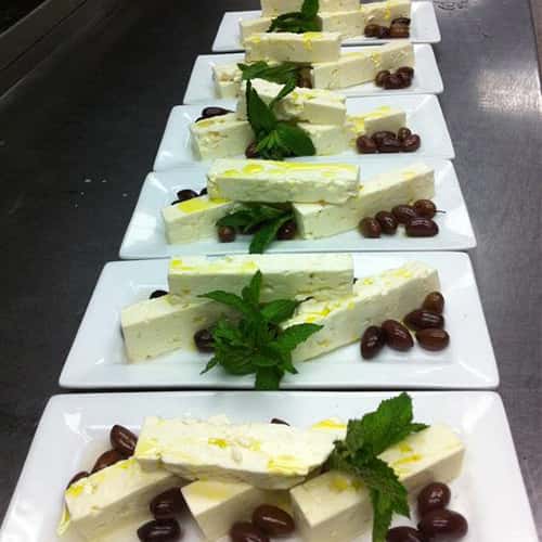 catering dishes with cheese and grapes