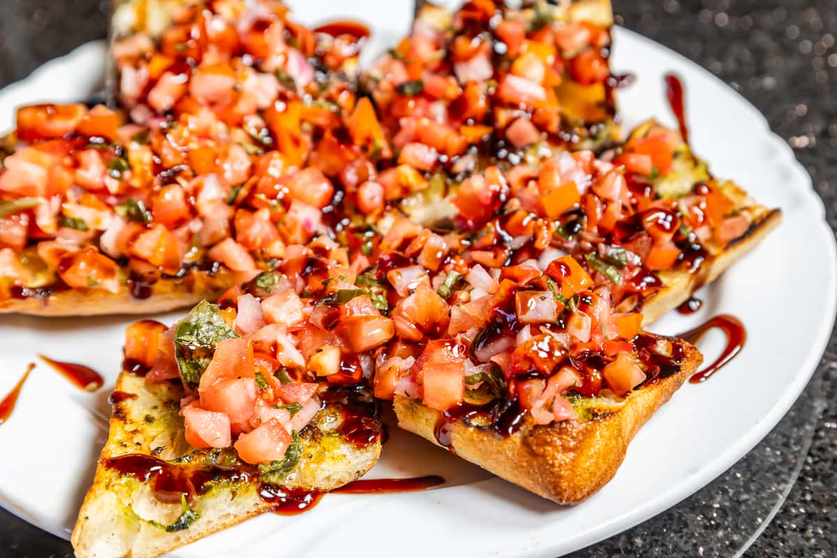 Bruschetta topped with diced tomatoes, herbs, cheese, and balsamic glaze at Gorat's Steak House