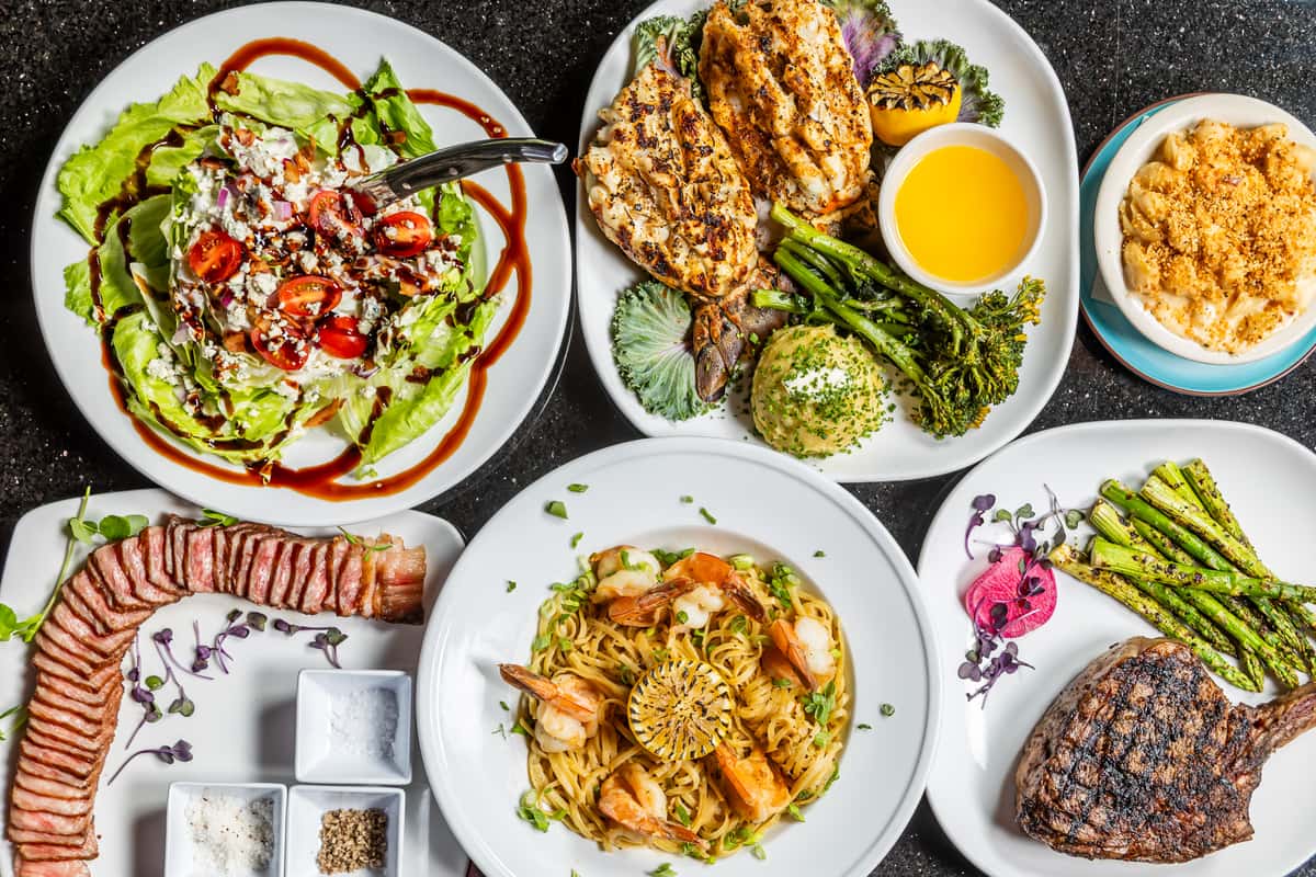 Selection of signature steaks, seafood, pasta, salads, and sides from Gorat's Steak House in Omaha