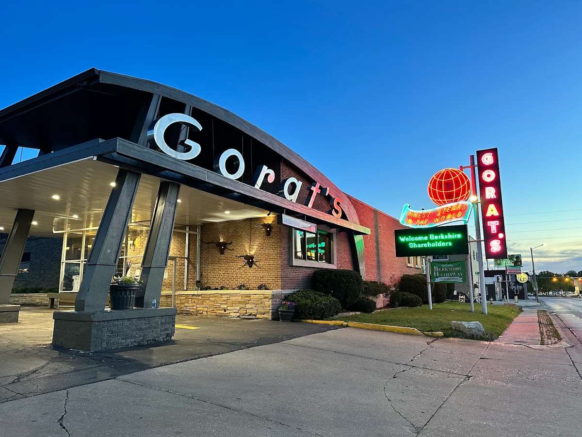 Exterior of Gorat's Steak House in Omaha, Nebraska, featuring the iconic neon sign and restaurant entrance at dusk.
