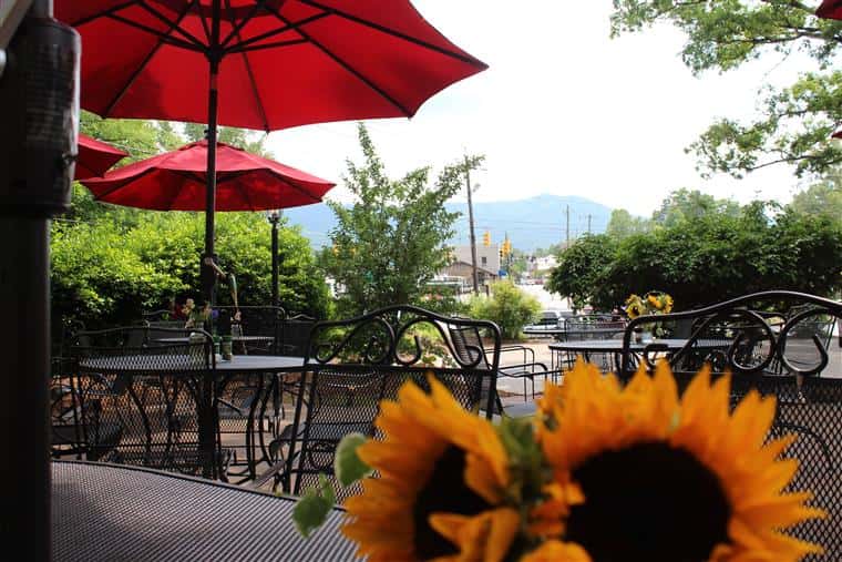 outside patio with tables covered by umbrellas