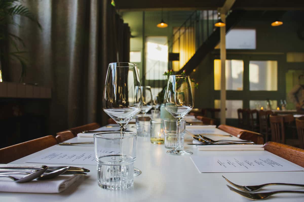 Dining table with glassware and menus